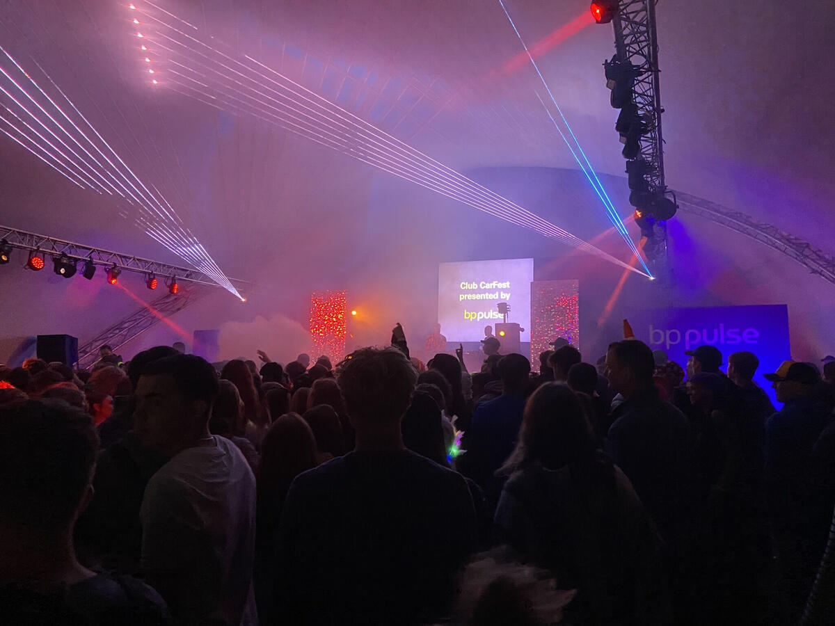 Henley Theatre Services illuminated in red lights and fireworks with a large crowd.